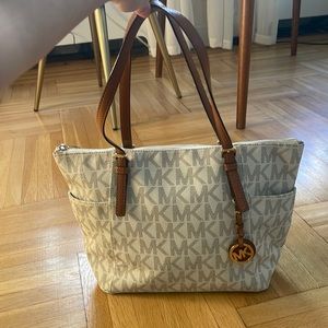 Michael Kors monogrammed jet set zippered tote with brown straps gold hardware